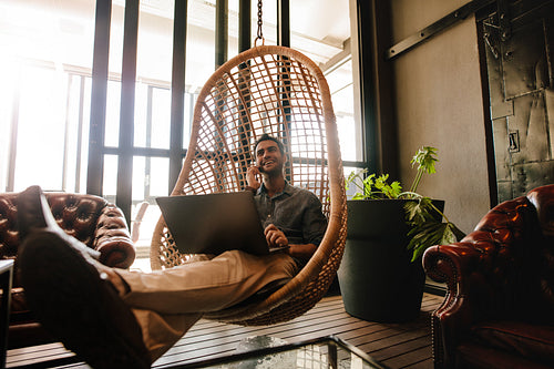 Business man relaxing in office lounge during break