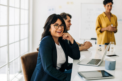 Professional business woman sitting in a boardroom meeting