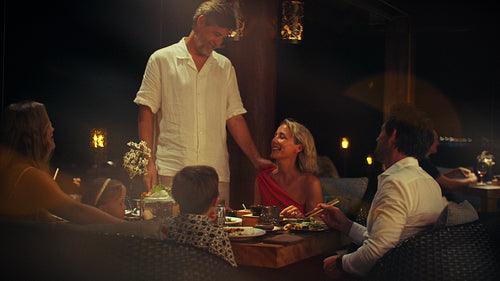 Loving couple shares a beautiful golden sunset moment during their romantic tropical vacation