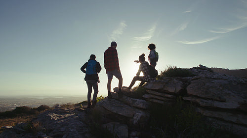 Friends resting on mountain top during hike