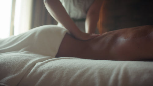 Young woman relaxing during a soothing back massage at a luxurious spa treatment center