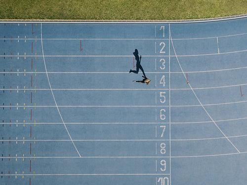 Track and field track with sprinter in overhead shot
