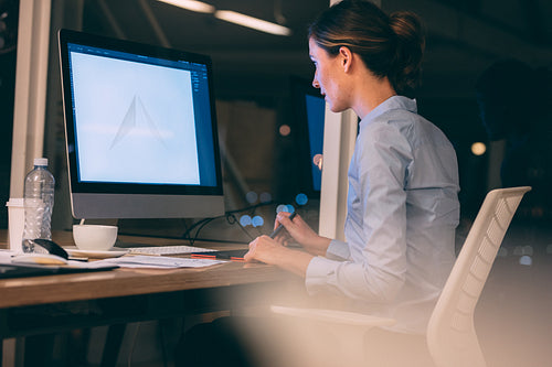 Woman working on computer at office