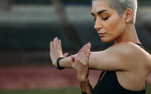 Close up of a fitness woman doing warm up exercises