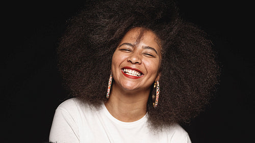 Portrait of a woman in afro hairstyle laughing