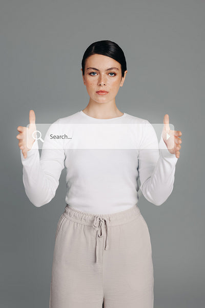 Tech-savvy woman holding a search bar icon in a studio