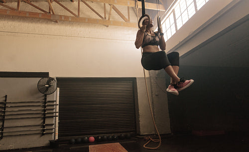 Woman doing workout on gymnastic rings