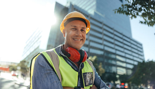 Cheerful workman smiling at the camera in the city