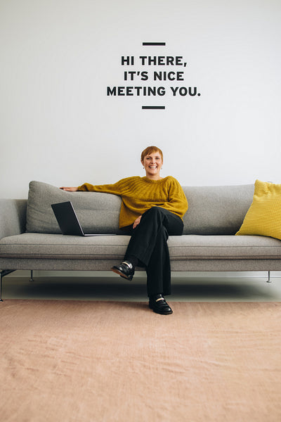 Happy female entrepreneur sitting at lobby