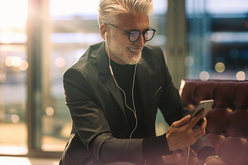 Businessman making video call in office lobby