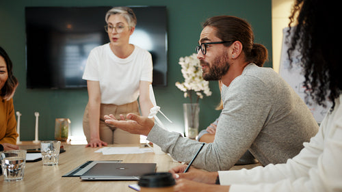 Group of business people planning a wind turbine project in a meeting