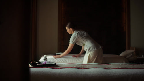 Preparing a luxurious spa massage bed for ultimate relaxation and well-being in a serene setting