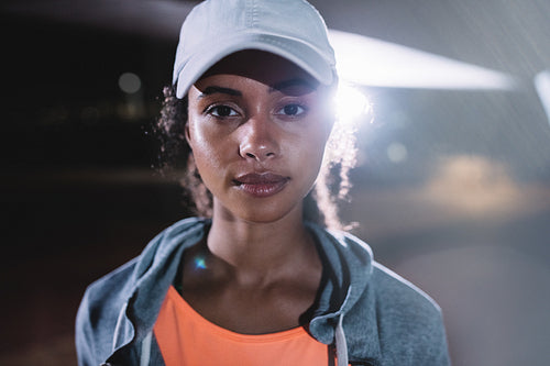 Urban female runner in city at night