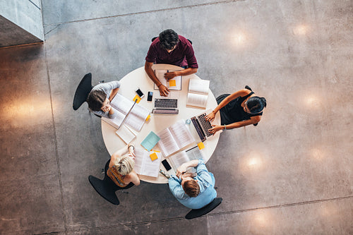 Young people studying together around a table