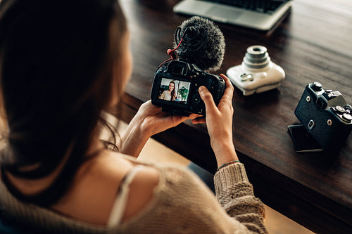 Female blogger reviewing her recorded content