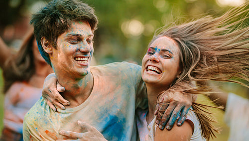 Happy couple playing holi together and having fun