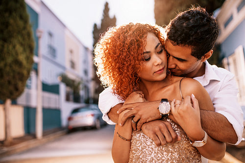 Young couple having fun in the street on a sunny day.