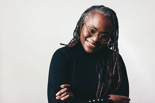 Happy professional woman smiling at the camera in a studio