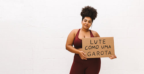 Plus size woman with "Fight like a girl" sign