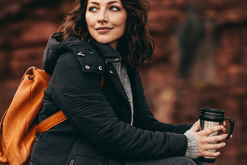 Female hiker resting with a coffee