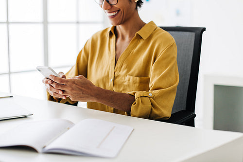 Business woman using a cellphone in an accounting firm