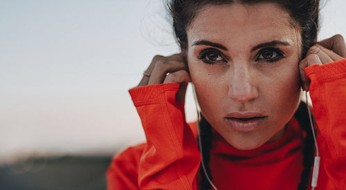 Female runner adjusting her earphones
