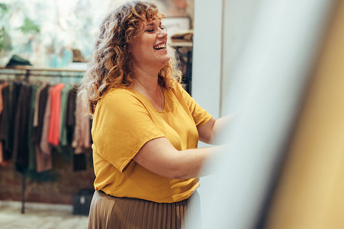 Woman buying clothes in store