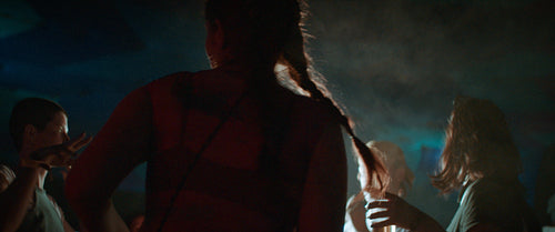 Energetic festival friends grooving in the smoke and lights