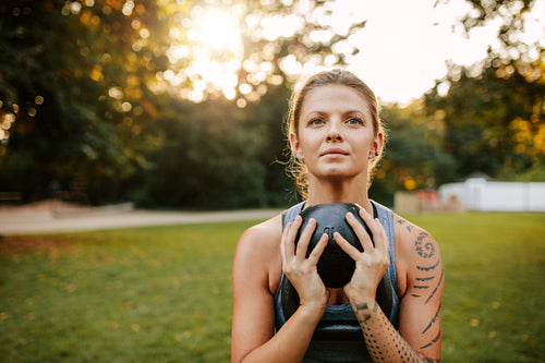 Fit young woman doing workout with kettlebell