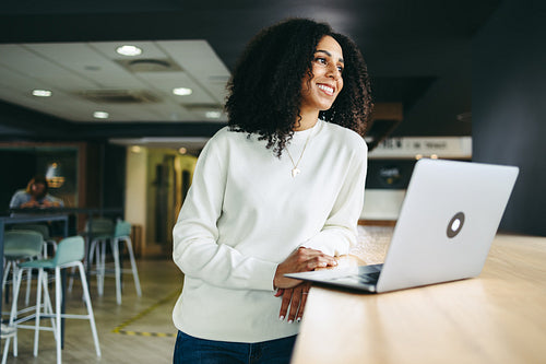 Happy businesswoman smiling in a co-working office