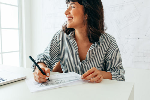 Close up of cheerful female architect at work