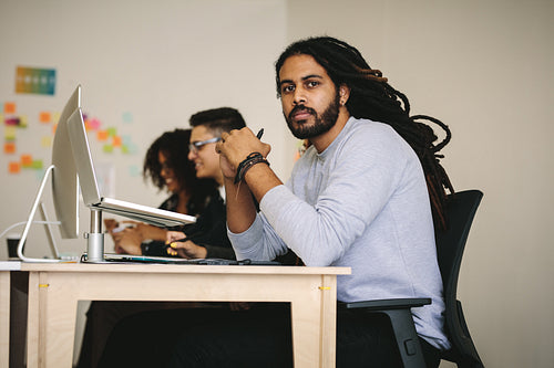 Business people in office working on laptops and computer