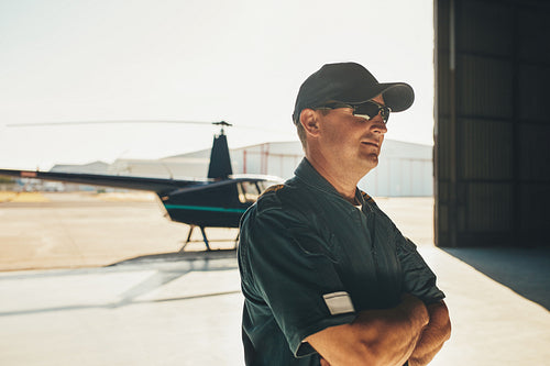Helicopter pilot in airplane hangar