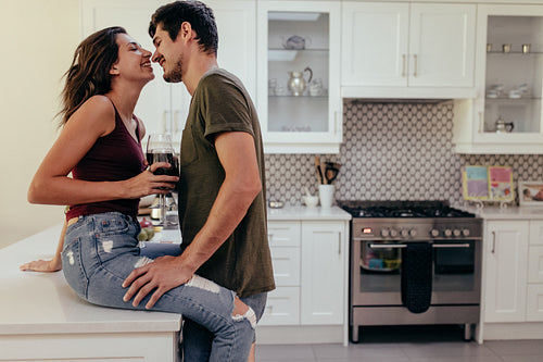 Couple romancing in kitchen