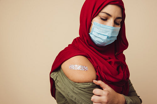 Muslim woman getting immunity vaccine from corona virus