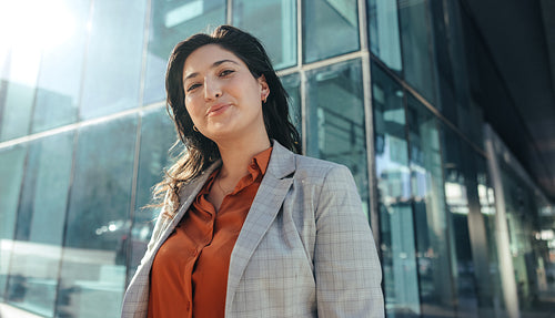 Carefree busineswoman smiling at the camera outdoors