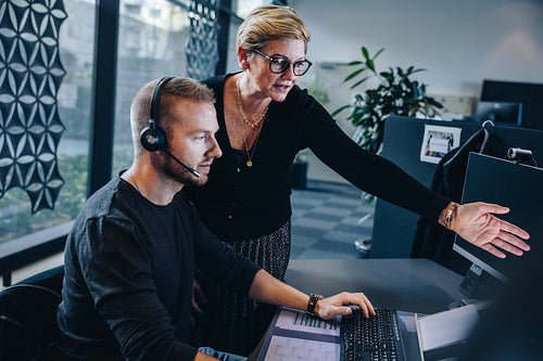 Manager assisting customer service agent to resolve an issue