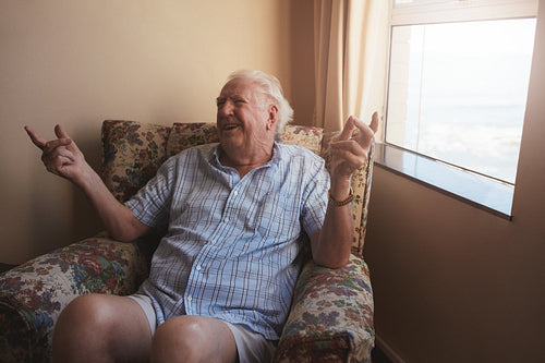 Senior man sitting in a arm chair