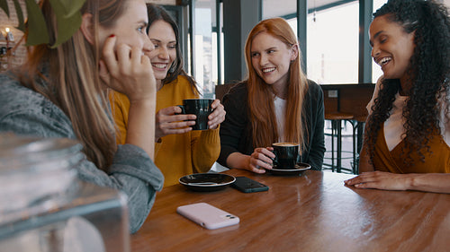 Group of female friends hanging out in a cafe