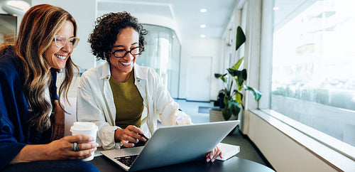 Business colleagues collaborating on laptop demonstrating teamwork