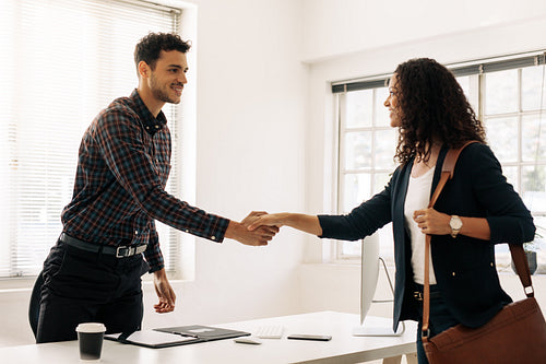 Business partners shaking hands after a meeting