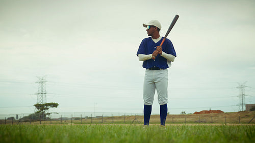 Baseball player practices batting on the field