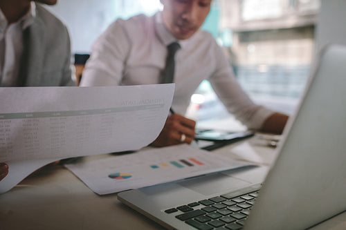 Two businessmen working together over documents