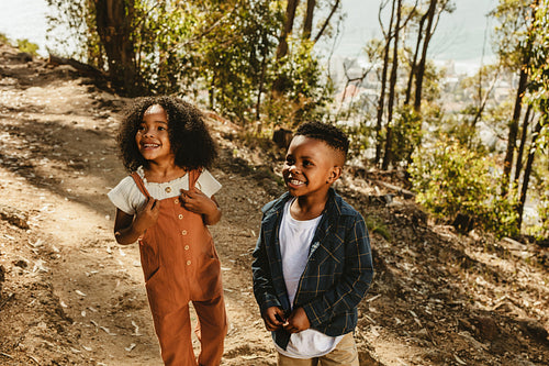 Beautiful two kids standing on a mountain trail