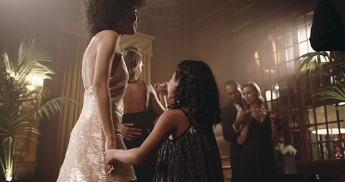 Mother and daughter dancing at gala night