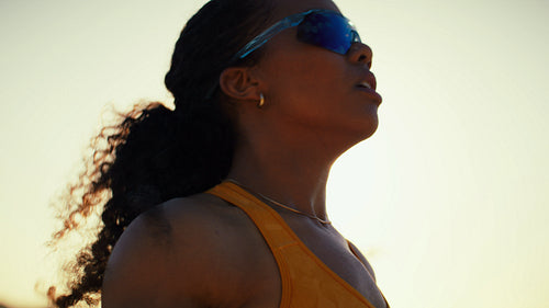 Close-up of skilled beach volleyball teammates at sunset