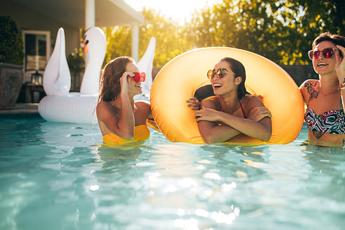 Smiling women enjoying in a pool