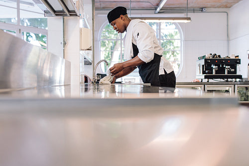 Man cleaning the kitchen counter
