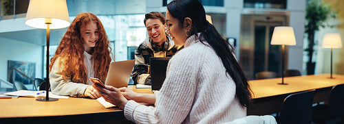 Students using phone during studying in library