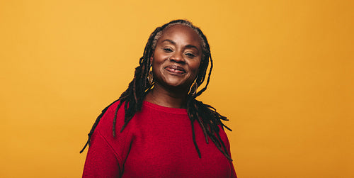 Portrait of a woman with dreadlocks smiling at the camera
